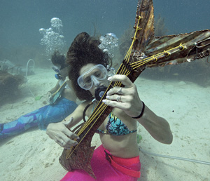 Participants might even catch "mermaids" and other costumed characters attempting to perform their own marine melodies — pretending to play underwater musical instruments.